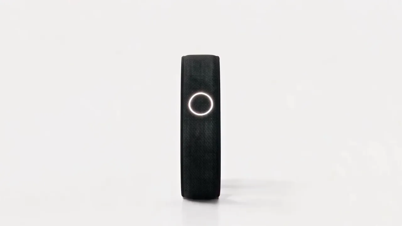 Persona Band in black Knit, standing on white, its light ring glowing