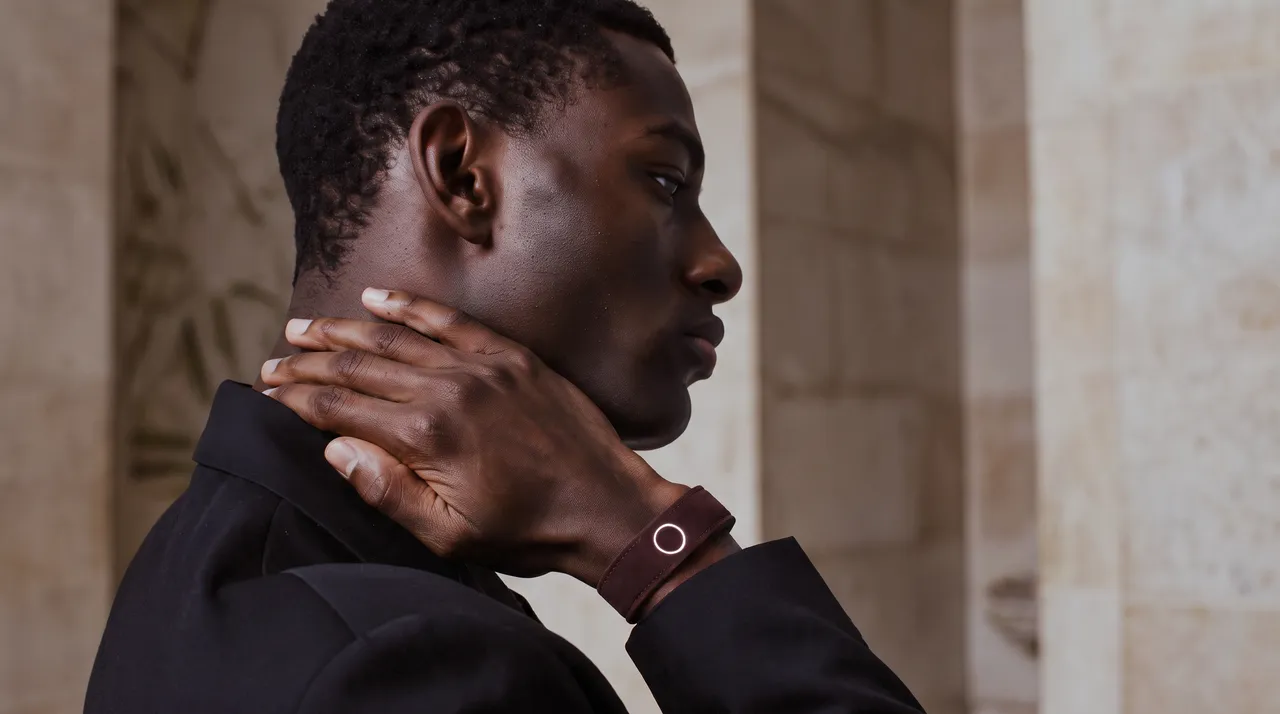 A man by stone columns wearing Persona Band, Suede in Brown Mocha