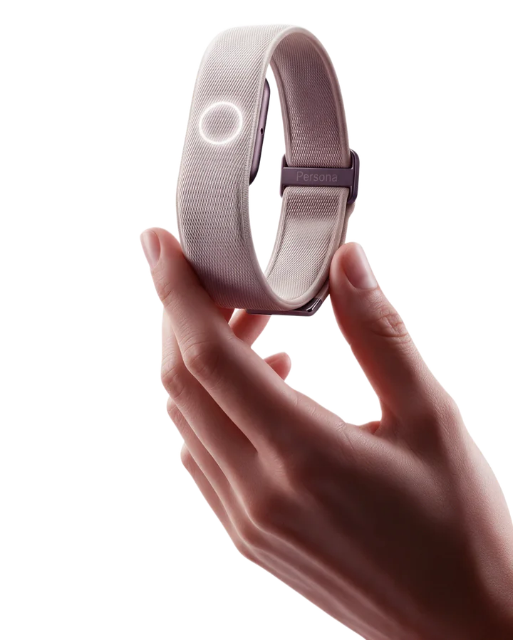 A hand holding up Persona Band, Knit in Cortina White, its ring lit